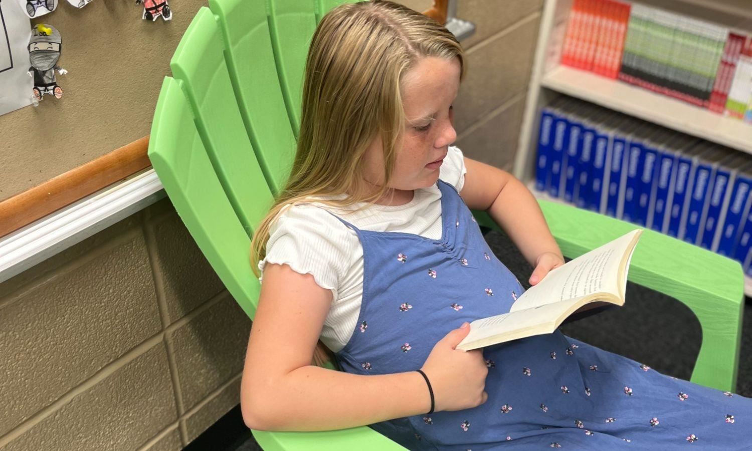 student reading in chair